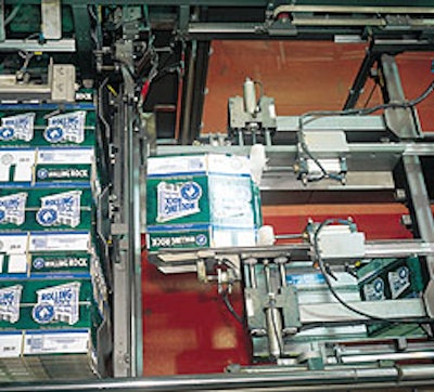 The system shown here includes a robotic positioner that picks a bundle of 12-count corrugated shippers, orients the bundle, cut