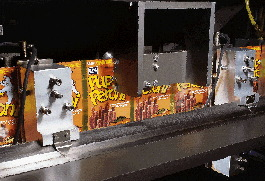 Sealing jaws heat-seal the two side edges from the bottom up through the ultrasonically-sealed top zipper area before a cut-off