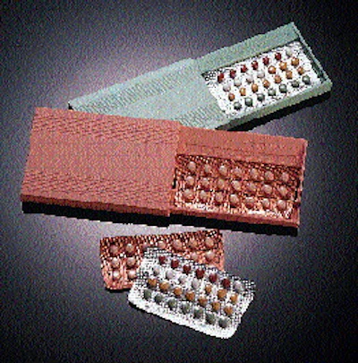 Prior to picking, blister packs travel through a long infeed section (above) and transfer to a white-ribbed flighted indexing be