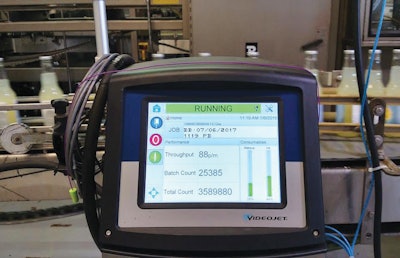 The closely coordinated system accurately delivers date codes and bar codes to bottles, shipping cases, and pallets.