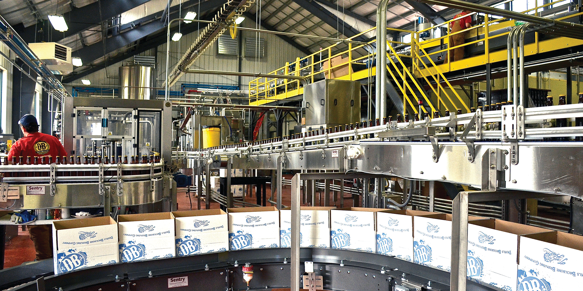 A high-level depalletizer single files and feeds bottles into a lowerator on their way down the line. Many of the equipment suppliers represented in the line are located near the brewery&rsquo;s Richmond, VA, location.