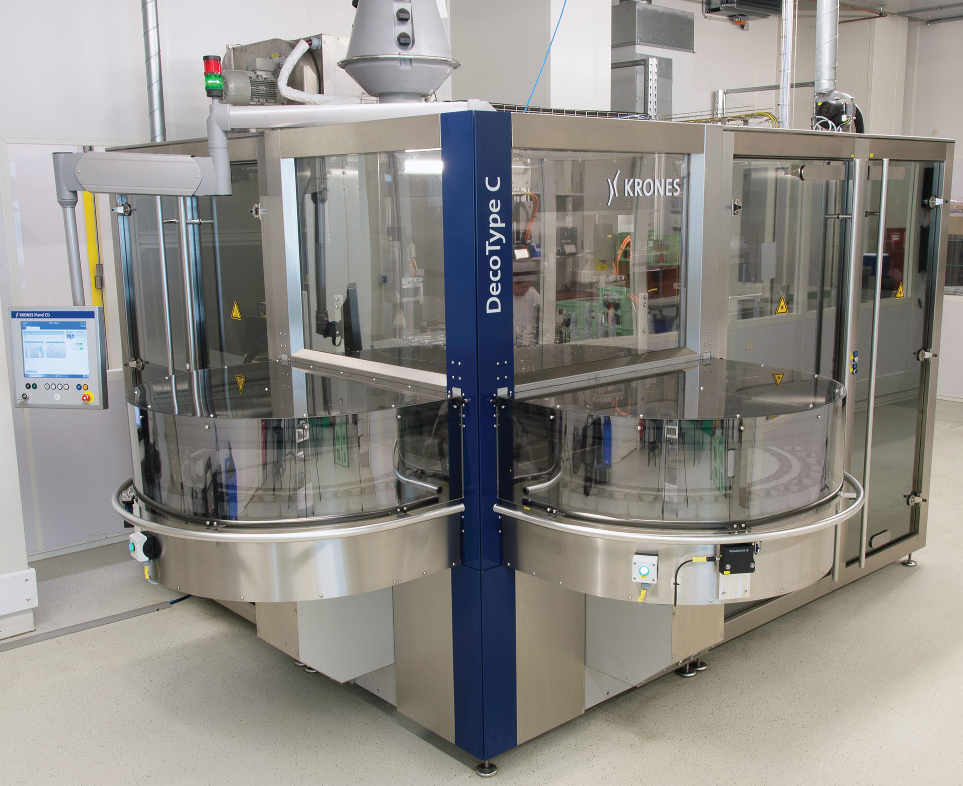 The infeed and discharge carousels of the DecoType C are prominent features of the machine.