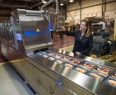 Harpak-ULMA COO Linda Harlfinger-Vogel interacts with the HMI of the company’s smart, connected machine.