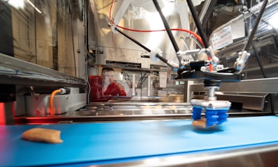 John Weddleton checks on the automation integrated into a thermoformer machine. Oftentimes, with food applications, the items are being thrown on a belt, and come in chaotically. The Harpak-ULMA automation system has the items fed and loaded into the machine at the rate of the machine, telling the robot where it is and grabbing the product no matter how it’s coming in and then loading it on to the next process.