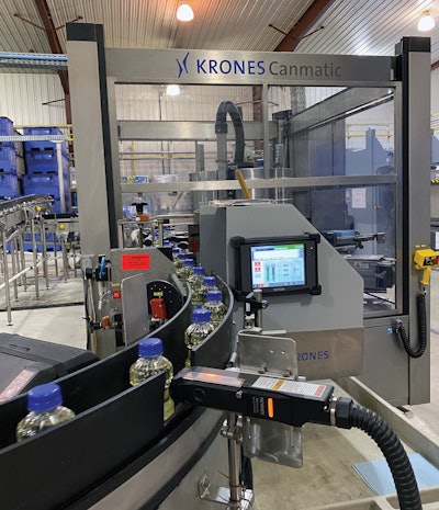 Exiting the labeler, bottles pass through an ink-jet unit for printing of date code.