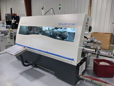Freshly welded can bodies emerge from this machine and move into a system that creates a flange on top and bottom, creates the beading on the sidewall, seams on a bottom, and seams on a top.