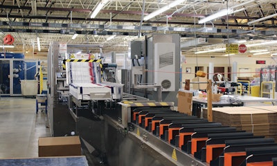 Colors that readily reflect light are easiest for the legally blind to see, so bright orange sheet metal plates were added between the article bucket openings as a color contrast to aid the operators in loading the article bucket pocket and preventing access to the bucket conveyor chains.