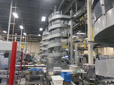 Each of the four wraparound case packers feeds a spiral conveyor that takes cases to an overhead level and on to palletizing.