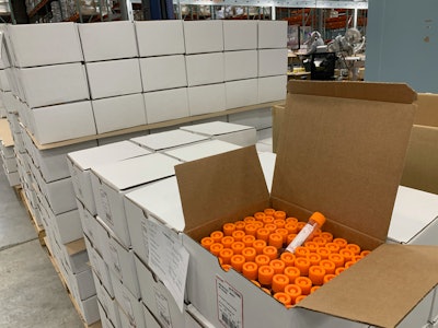 After inspection, tubes are passed to an operator to fill 72-count boxes in Lenexa.