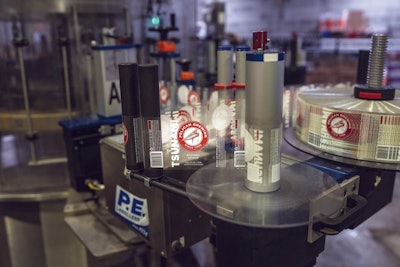 The rotary labeler affixes clear p-s labels, from rollstock, onto clear brown 12 oz. bottles. These clear labels put the beer first, even at the expense of billboard space.