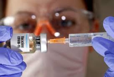 A medical worker prepares a syringe to administer the BioNTech/Pfizer COVID-19 vaccine.