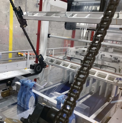 Shrink bundler unitizes bottles in three packs that then proceed to the case packer.