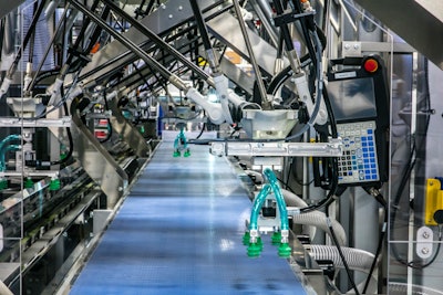 Spider robots sit atop a conveyor on one of Serpa’s intermittent cartoners.