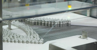 Depalletized canisters are oriented for automated processing.