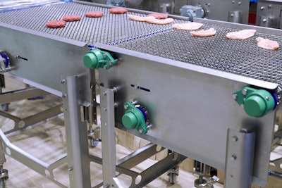 A conveyor with open construction moves meat products across a belt suitable for use in hygiene-sensitive applications.
