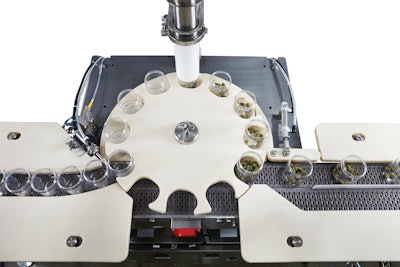 A starwheel carries cleaned, empty jars from an initial scale, then underneath a filler, and finally to a second scale that weighs the filled jar.