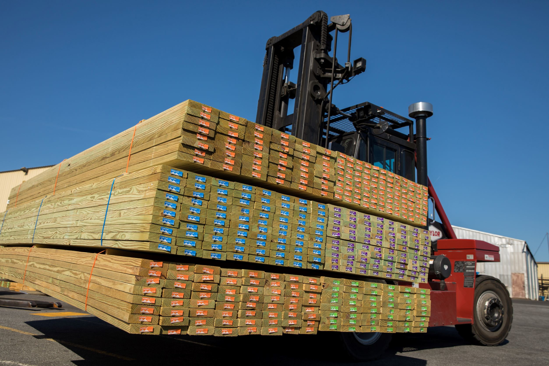 End tags for Culpeper&rsquo;s pressure-treated lumber, which are stapled to the end of the product, use a solid-color background to differentiate type.