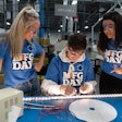 Students on Manufacturing Day do quality control checks on LED lighting systems on the factory floor at LumaSmart, a lighting manufacturer in Michigan.