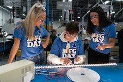 Students on Manufacturing Day do quality control checks on LED lighting systems on the factory floor at LumaSmart, a lighting manufacturer in Michigan.