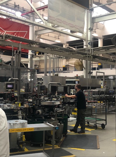 Workers monitor the packaging line at Anheuser-Busch’s facility in St. Louis.