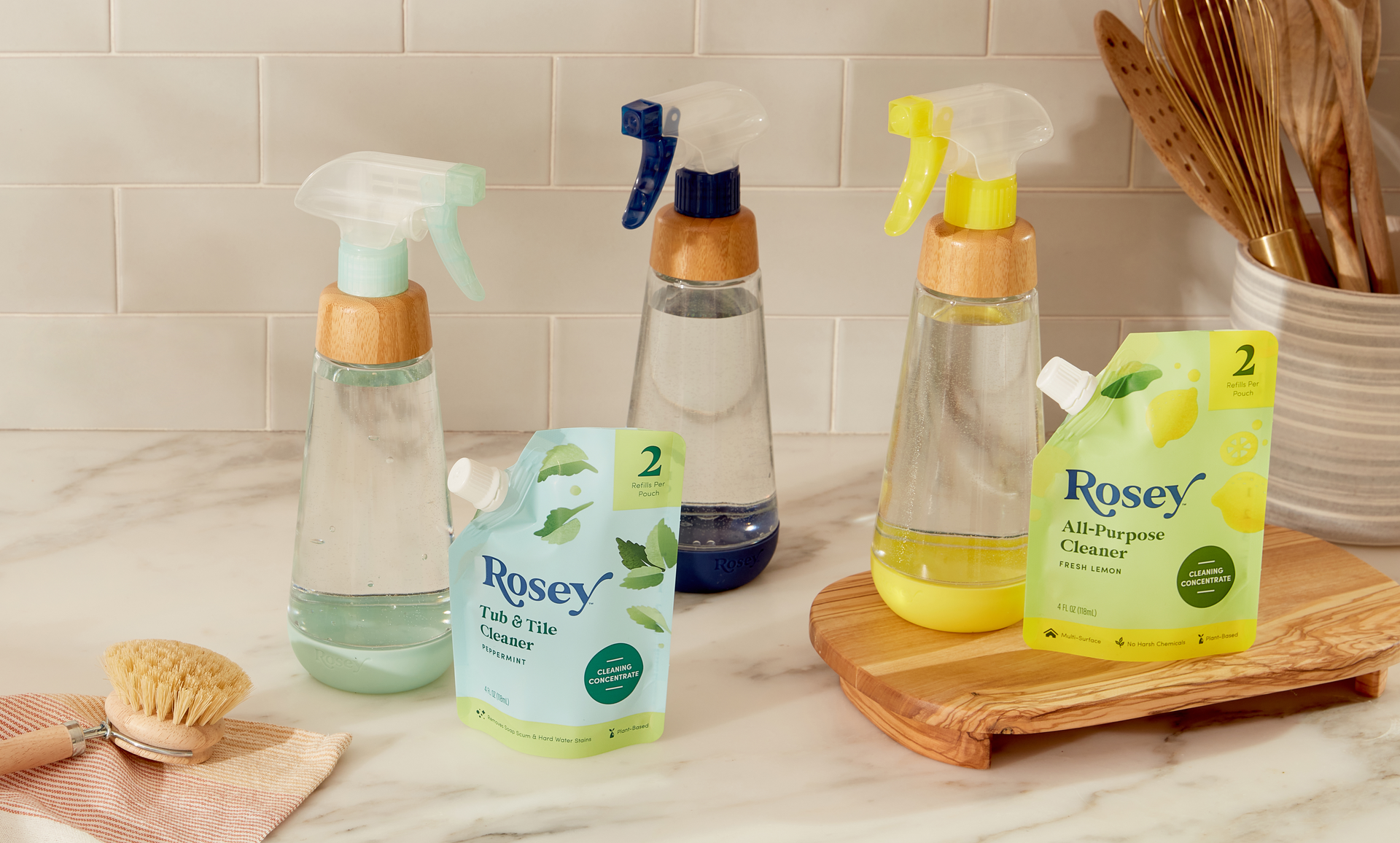 Thrive Market&rsquo;s new Rosey line of household cleaning products includes three refill/reuse option, pairing concentrate in a flexible pouch with counter-worthy, reusable glass bottles.