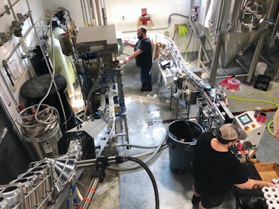 Depalletized brightstock cans travel through a twist rinser into a filler and seamer, prior to date coding, labeling, and paperboard multipacking.