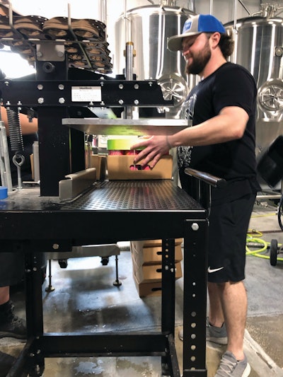 This version of WestRock’s fiber-based CanCollar system uses a manual station called “the Chunk” to apply paperboard can handles to 12- and 16-oz 6-packs.