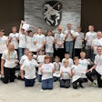 Summer Manufacturing Camp attendees and supervisors, including Todd Kruse (right), pose for a group photo at Legacy Christian Academy.