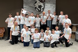 Summer Manufacturing Camp attendees and supervisors, including Todd Kruse (right), pose for a group photo at Legacy Christian Academy.