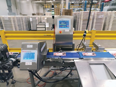 Checkweighing and metal detection are the first operations after cartoning (shown). For any given product run, the weights of the first handful of cartons off the line are checked, and the system calibrates for 16- or 17-ct layers to narrow in on the 10.5-oz desired carton weight.