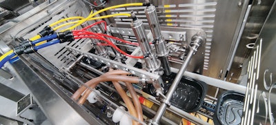 This photo, shot at the Orics facility before equipment was shipped to Artisan Chef, shows the alignment of the four pumps that deposit sauce onto pasta on the ready meals line.
