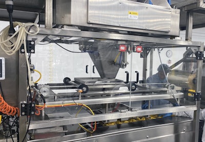 The upstream thermoformer on the ravioli line sends formed trays into the filling station two across. But a servo-driven shuttle system combined with a divider makes it possible to fill four memory buckets at a time, so filling is done four-up.