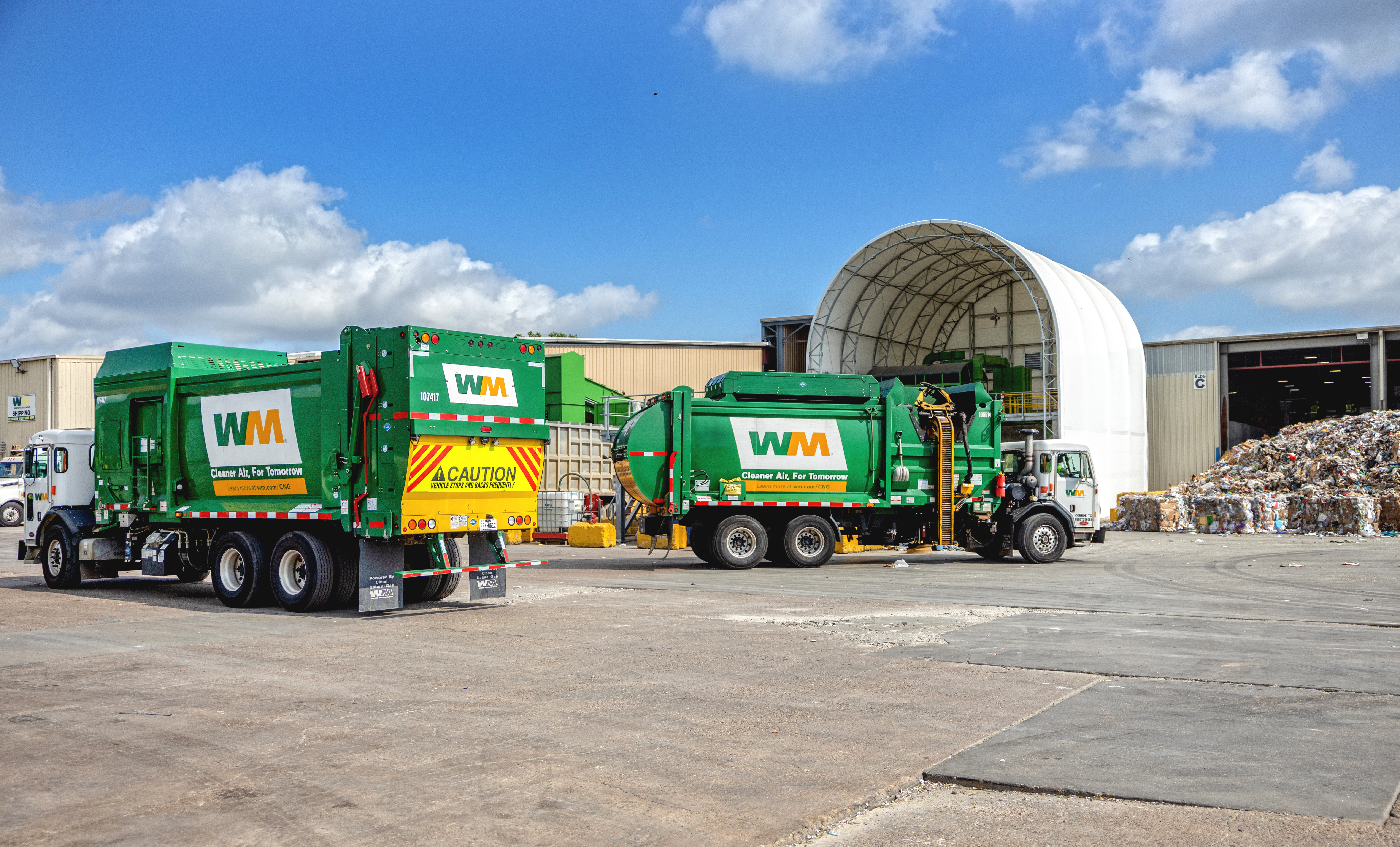 Haulers feed the tipping floor at WM's new Houston West Side material recovery facility (MRF).