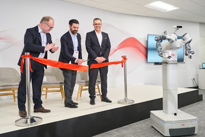 ABB's Marc Segura, John Bubnikovich, and Sami Atiya cut the ribbon at the grand opening of ABB Robotics' renovated facility.