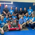 The L.C. Bird RoboHawks gather around their robot with Dana Greenly (top right), Katy Clarke (bottom right), and members of BPA.