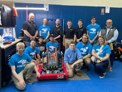 The L.C. Bird RoboHawks gather around their robot with Dana Greenly (top right), Katy Clarke (bottom right), and members of BPA.