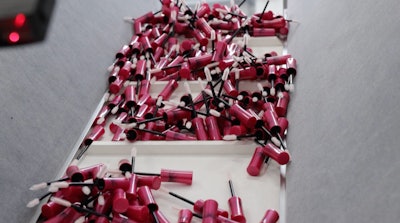 Brush, wand, and cap assemblies enter the filling and closing monoblock.