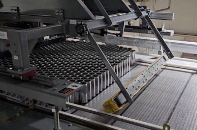 Empty cans enter the system on an overhead depalletizer.