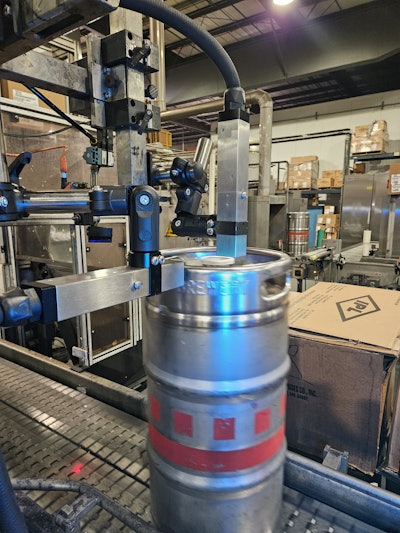 Two new CIJ printers are used on a keg line, one for printing on the top of each keg and the other for printing on the side.