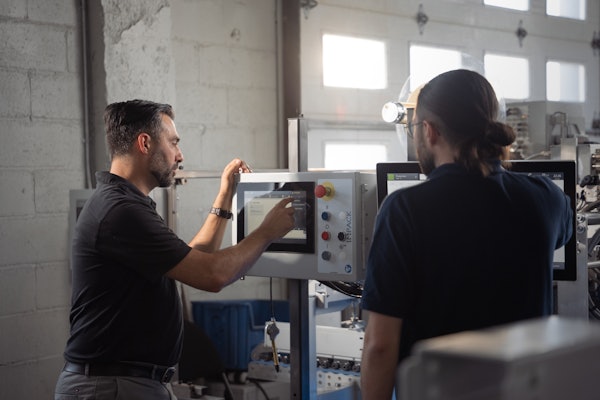 Frédéric Boyadjian, head of automation, and Cédric Gaudreault, automation designer, fine-tune the settings of Impack’s new automation app on a GenieCut.