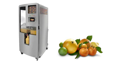 Commercial juice machine next to assorted citrus fruits including oranges, lemons, and limes