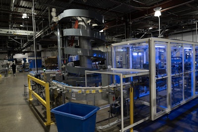 Cartons exit pass through a metal detector before making a turn leading to the case packer. Finished cases or trays then travel by way of a spiral conveyor that takes them to an overhead conveyor leading to the warehouse.