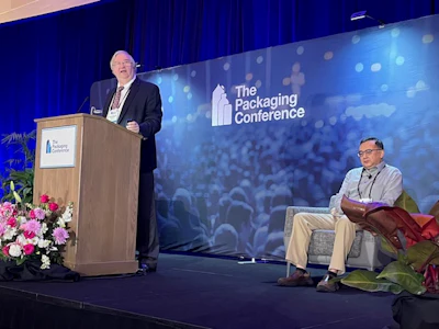 Paul Tatarka, Market Development , Polyplastics USA (left), presents with Jun Wang, Director, Packaging Innovation, Colgate-Palmolive Company.