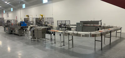 An example production line in the showroom gives a sense of equipment footprint, from case erecting to robotic palletizing.