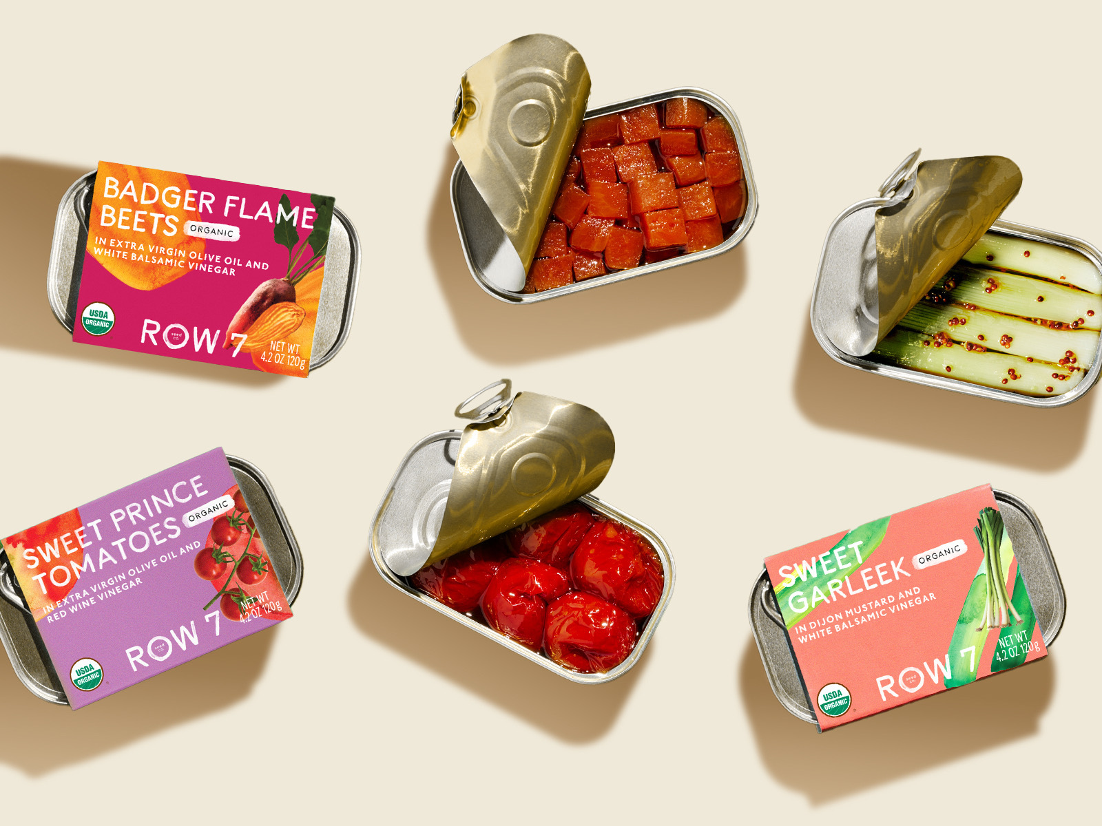 Row 7&rsquo;s tinned vegetables are packed in small-format tins with paperboard sleeves that leave the container visible, reinforcing the brand&rsquo;s produce-aisle positioning and connection to fresh, flavor-bred vegetables.