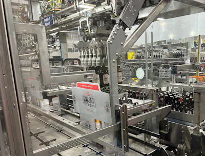 One of two robotic pickers responsible for picking bottles from a four-lane infeed conveyor and placing them into paperboard carriers that are already inside their corrugated cases