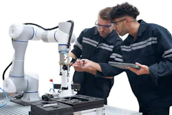 Two technicians examine a white and blue collaborative robotic arm while reviewing documentation on a tablet.
