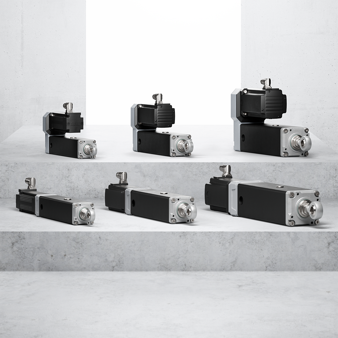 Industrial stepper motors and linear actuators in varying sizes displayed on concrete surface