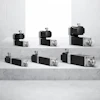 Industrial stepper motors and linear actuators in varying sizes displayed on concrete surface